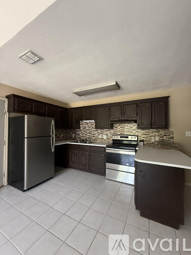 A kitchen with a refrigerator, stove, and oven.