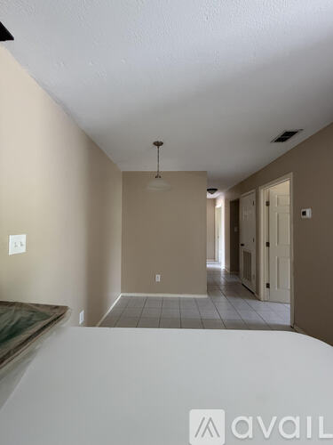 A room with beige walls and a tiled floor.