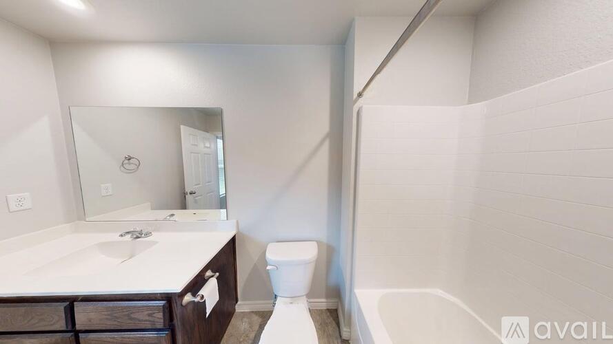 A bathroom with a toilet, sink, and bathtub.