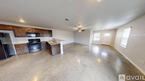 A spacious kitchen with wooden cabinets and a central island.