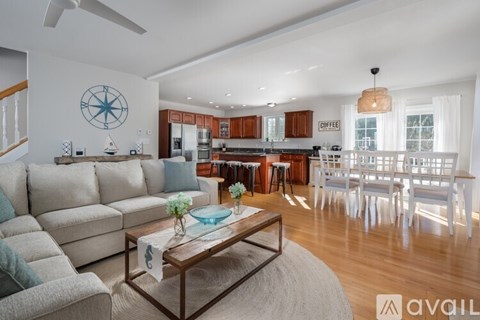 A living room with a compass on the wall and a coffee table in the center.