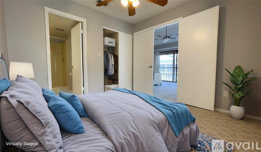 A bedroom with two beds and a ceiling fan.
