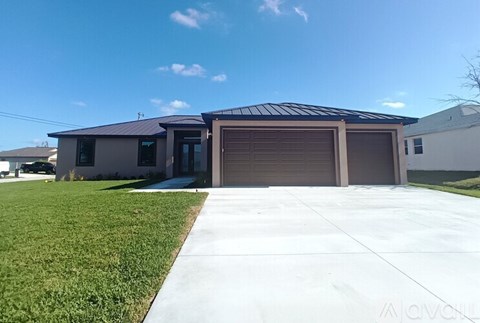 A two-car garage with a brown door is situated in front of a house.