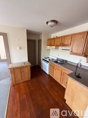A kitchen with wooden cabinets and a white countertop.
