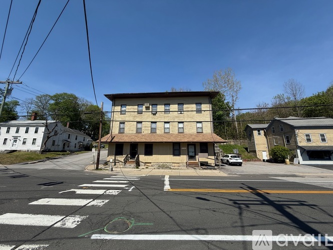 A street view with a crosswalk and a building in the background.