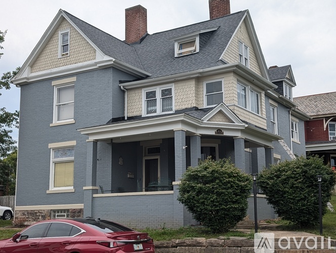 A house with a red car parked in front.