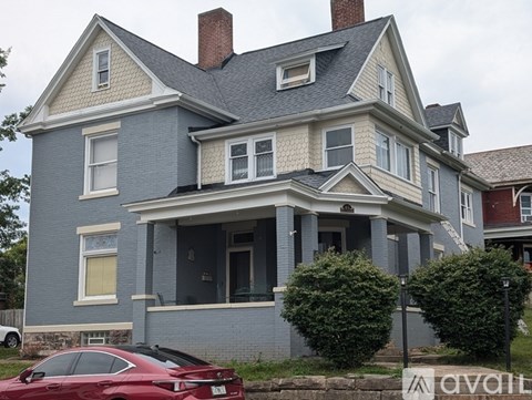 A house with a red car parked in front.