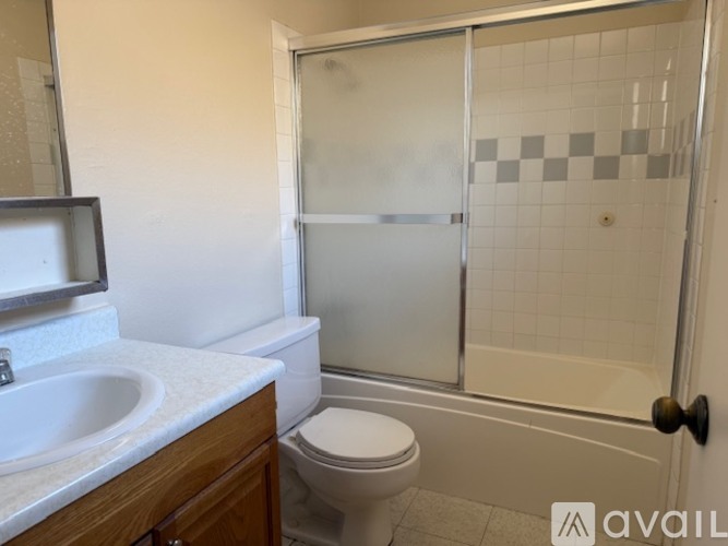 A bathroom with a toilet, sink, and shower.
