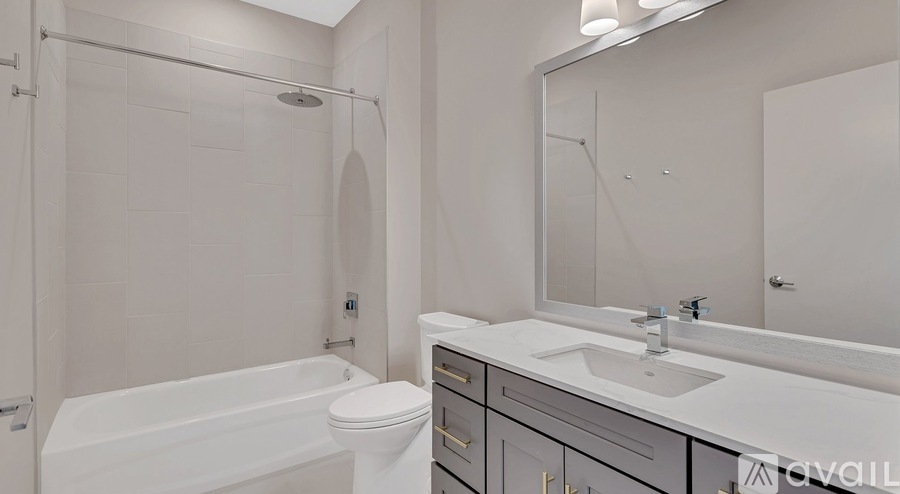 A white bathroom with a sink, toilet, and bathtub.