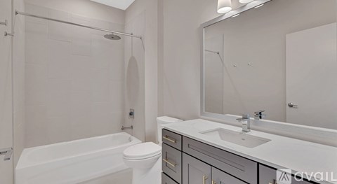 A white bathroom with a sink, toilet, and bathtub.