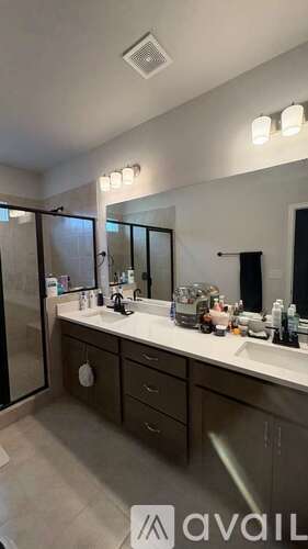 A bathroom with a sink, mirror, and cabinets.