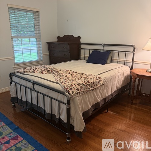A bed with a leopard print blanket is in the image.