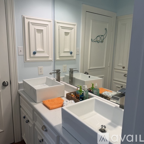 A bathroom with two sinks and a mirror.