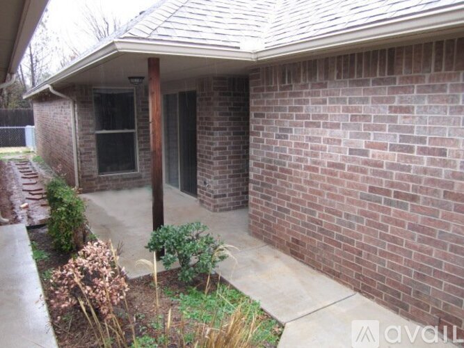 A house with a red brick wall and a brown door.