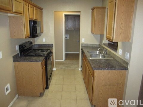 A kitchen with wooden cabinets and granite countertops.