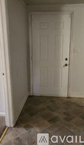 A white door in a room with a tiled floor.