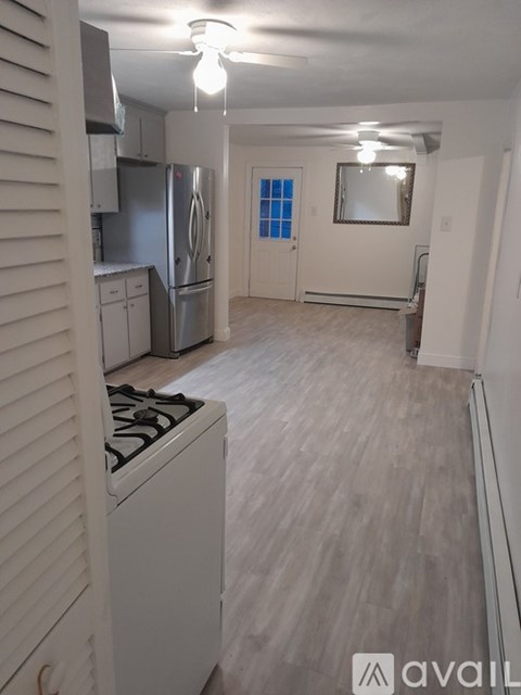 A kitchen with a stove top oven and a refrigerator.