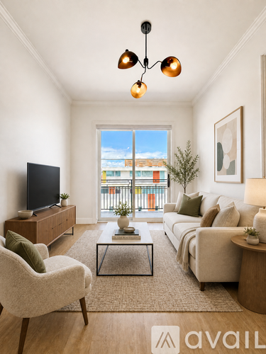 A living room with a television, sofa, and chair.