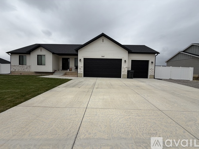 A two-story house with a garage is available for sale.