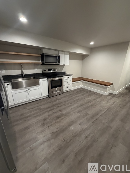 A kitchen with a refrigerator, oven, microwave, and cabinets.