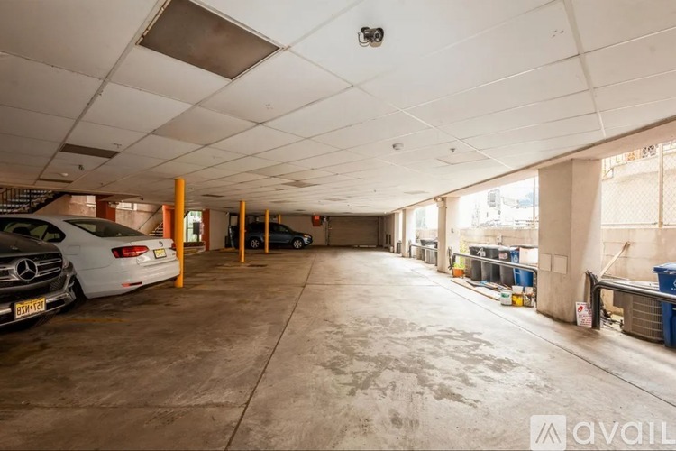 A spacious garage with a Mercedes-Benz parked inside.