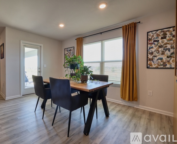 A dining room with a wooden table and chairs.