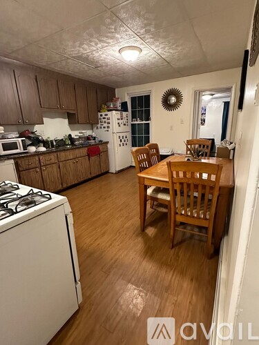 A kitchen with wooden floors and furniture.
