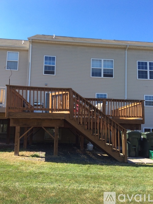A wooden deck with stairs leading to a building.