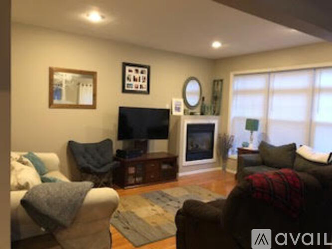 A living room with a fireplace and a television.