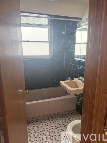 A bathroom with a bathtub, toilet, and sink.