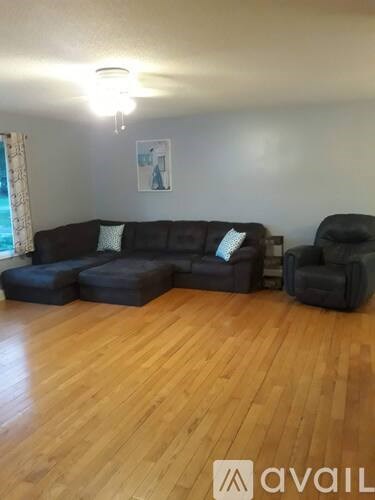 A living room with a couch and a chair.