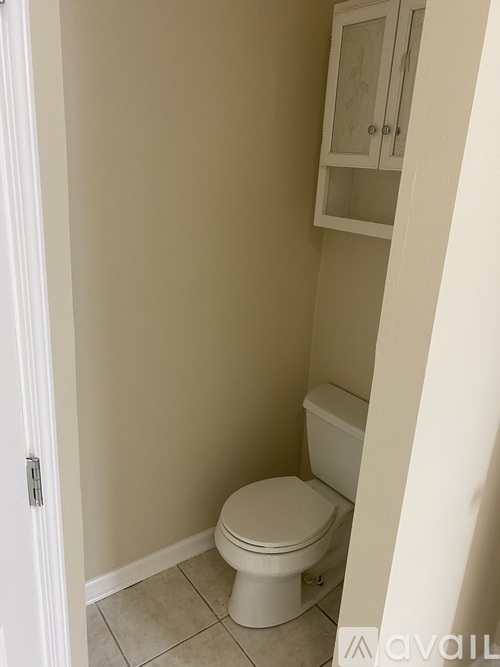 A white toilet in a small bathroom.