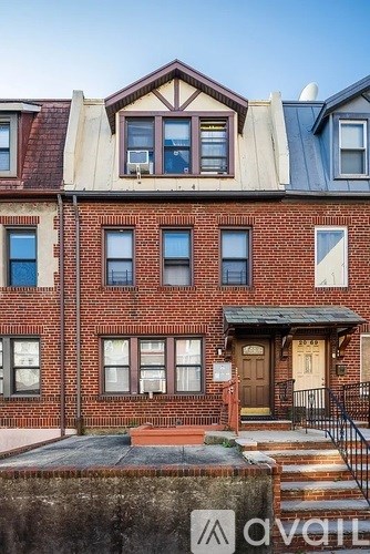 A red brick building with a brown door and windows.