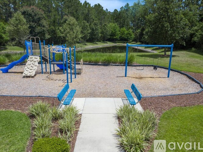 A playground with a blue swing set and a yellow slide.