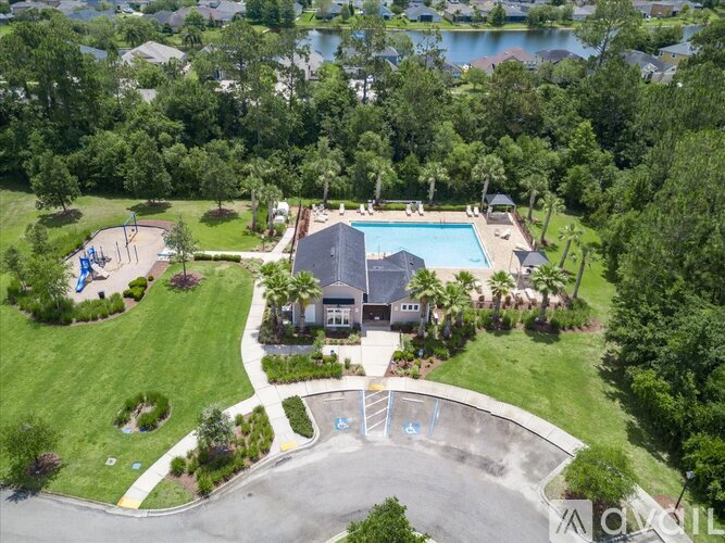 A bird's eye view of a residential area with a swimming pool and a playground.