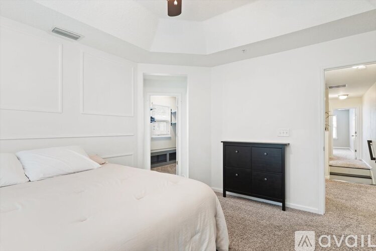 A bedroom with a large bed and a black fireplace.