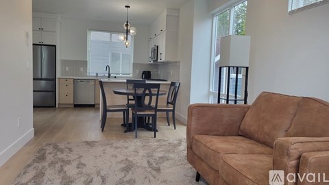 A modern kitchen with a dining table and chairs.