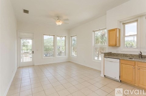 A kitchen with white appliances and wooden cabinets.