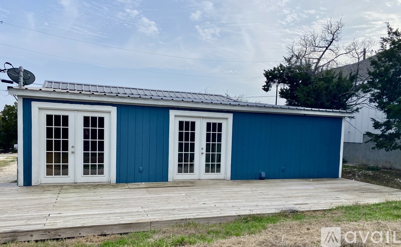 A blue building with a satellite dish on top.
