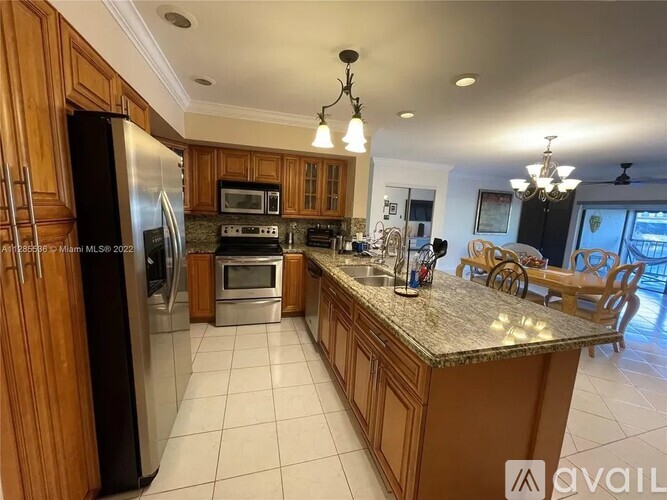 A kitchen with wooden cabinets and a granite countertop.