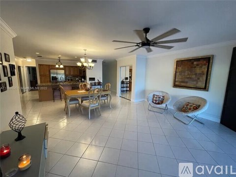 A living room with a dining table and chairs.