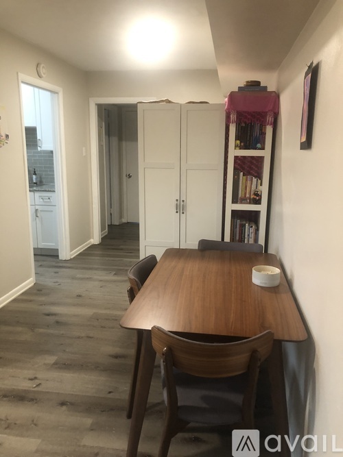 A dining room with a wooden table and chairs.