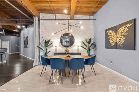 A dining room with a wooden table and blue chairs.