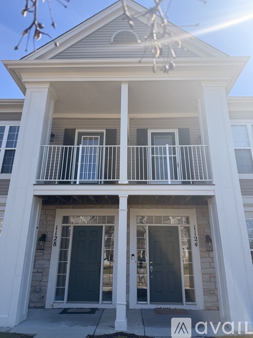 A two-story house with a balcony and a door numbered 1208.