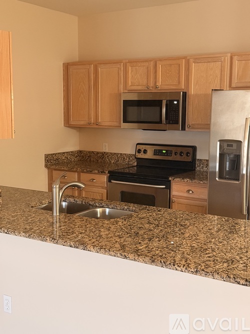 A kitchen with granite countertops and stainless steel appliances.