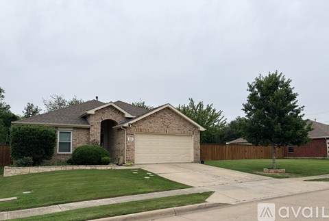 A house with a garage and a driveway in front.