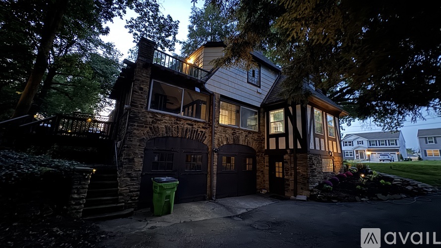 A house with a garage and a driveway is available for sale.
