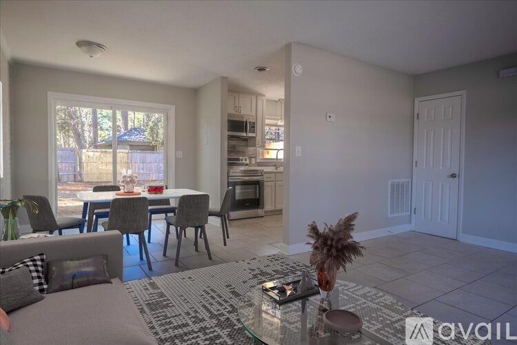 A living room with a dining table and chairs.