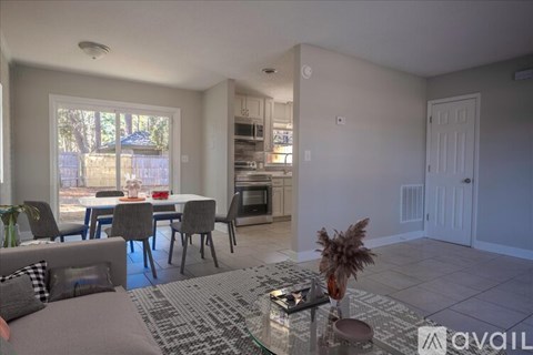 A living room with a dining table and chairs.