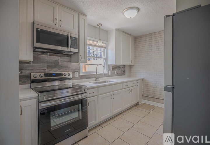 A kitchen with a black oven and a black fridge.